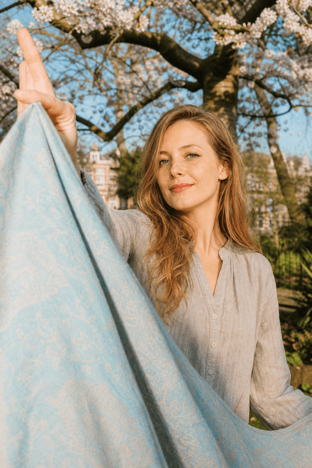 Spring portrait with fabric movement, natural light, and restrained colour.