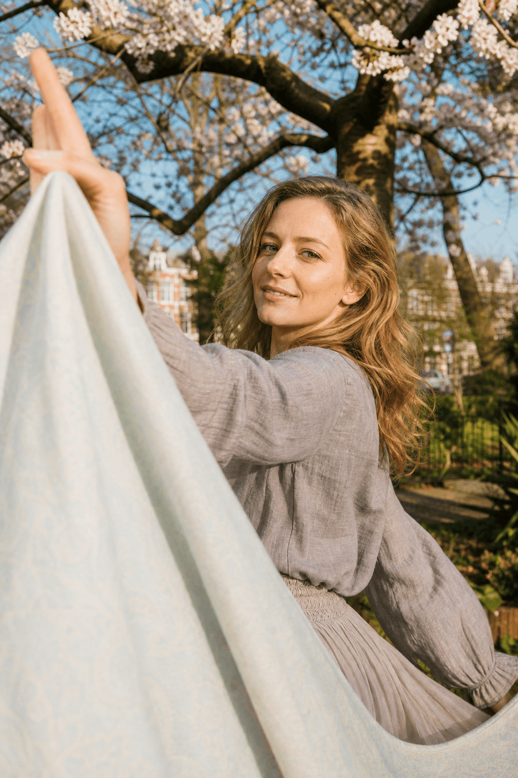 Directed portrait with soft movement and spring garden atmosphere.
