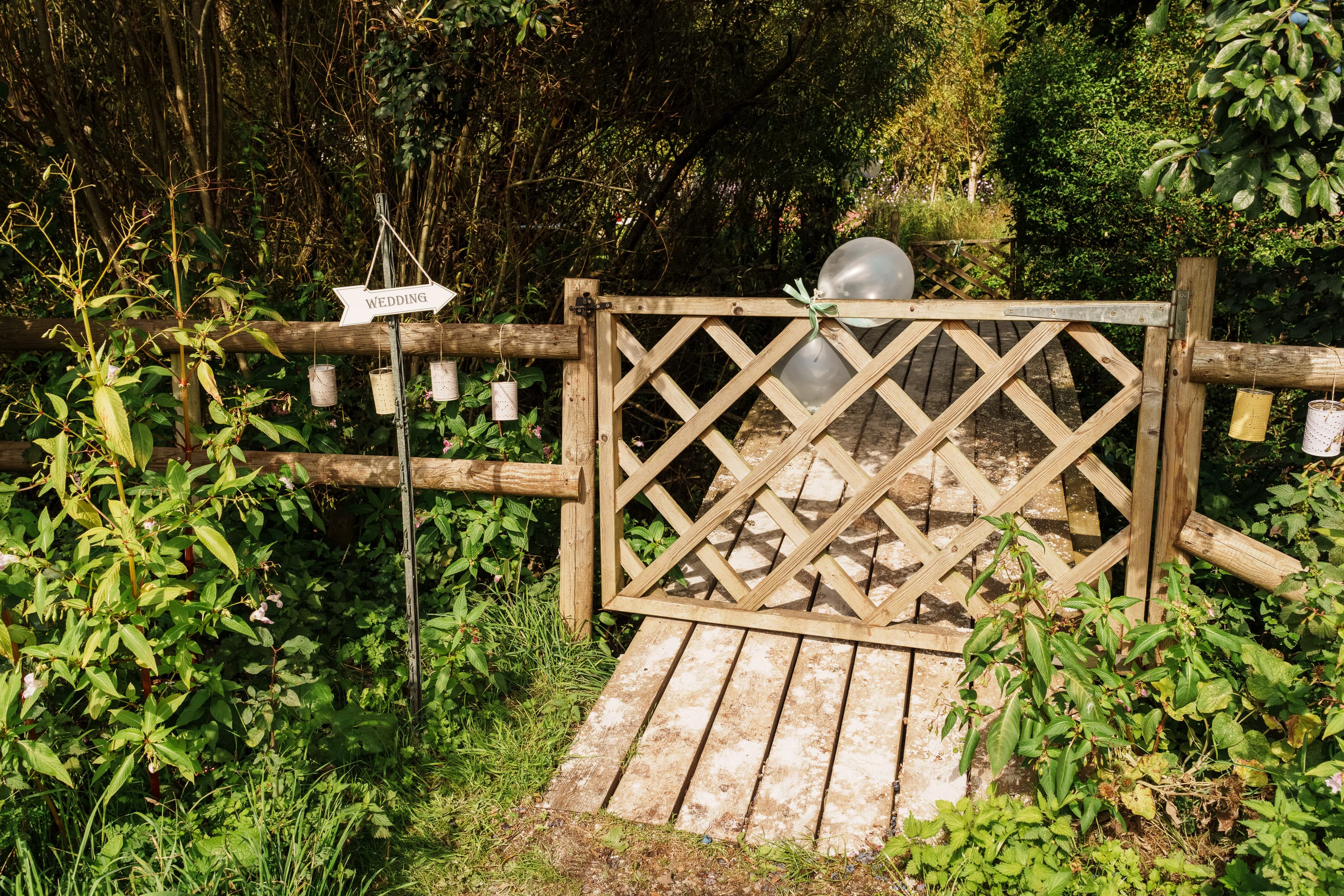 The entrance gate and wedding sign marking the first threshold into the venue.