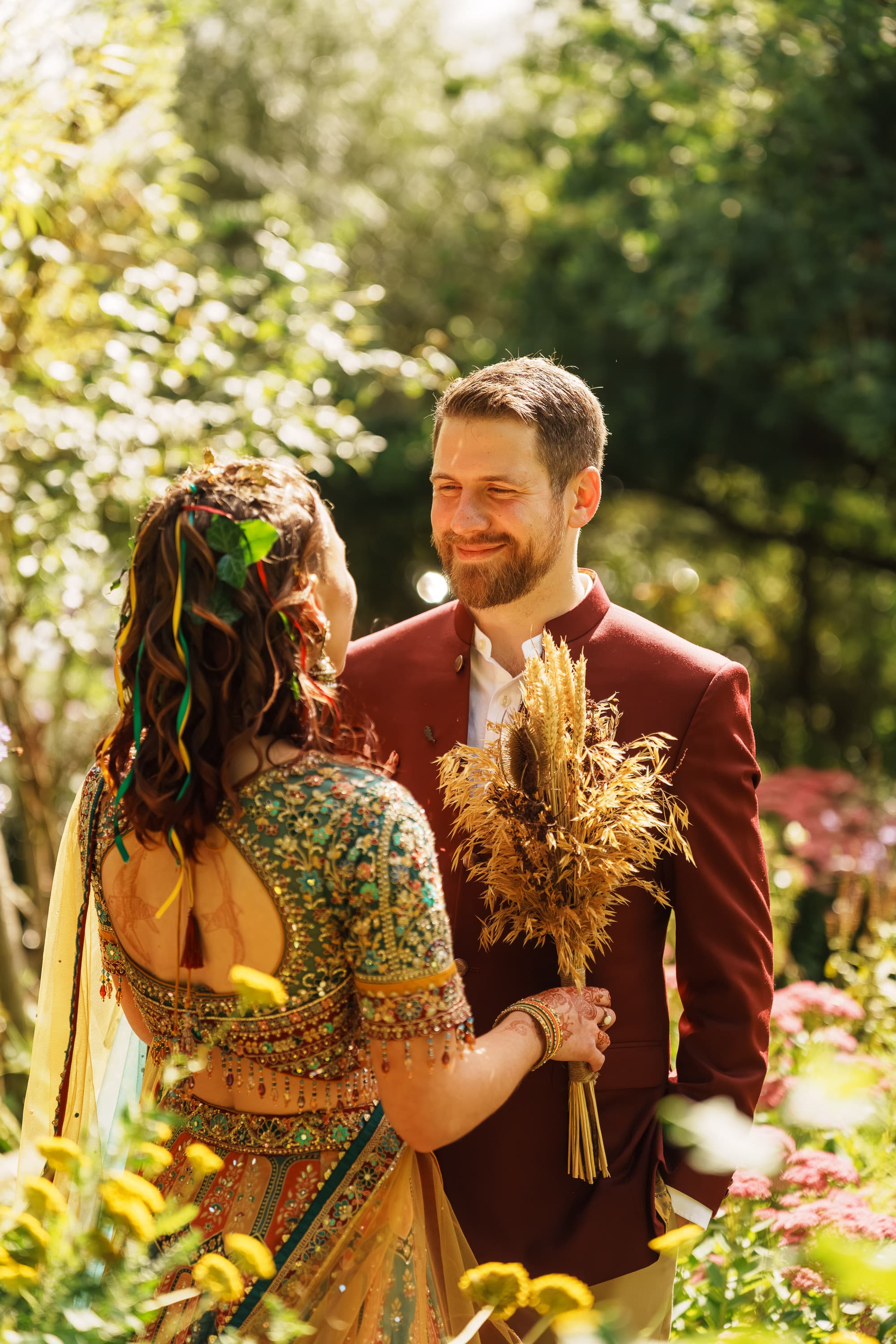 Adam smiling toward Sarah in the garden as the afternoon briefly narrows to the two of them.