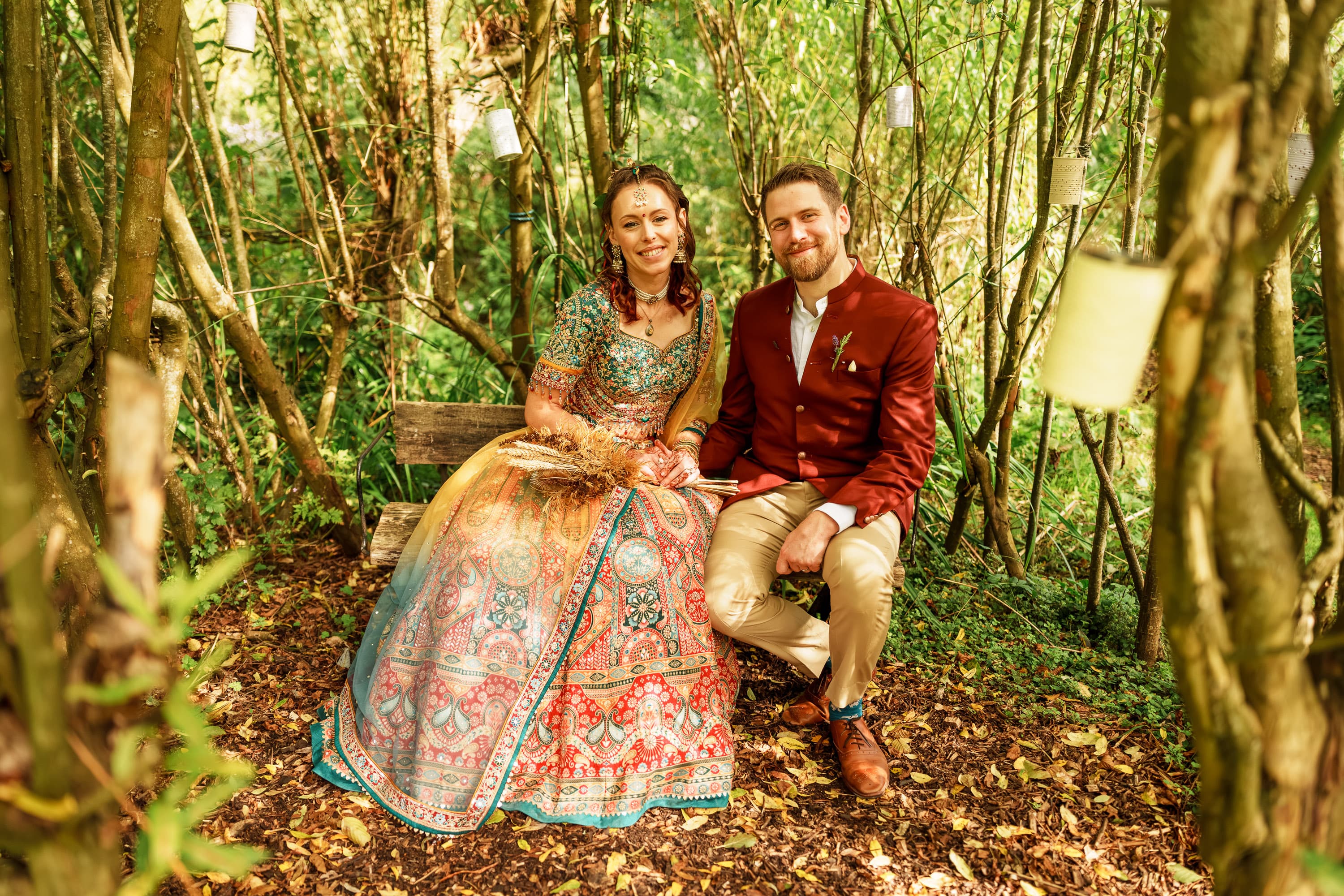 Adam and Sarah sitting together in the woodland as the portrait interval settles into something calmer and more complete.