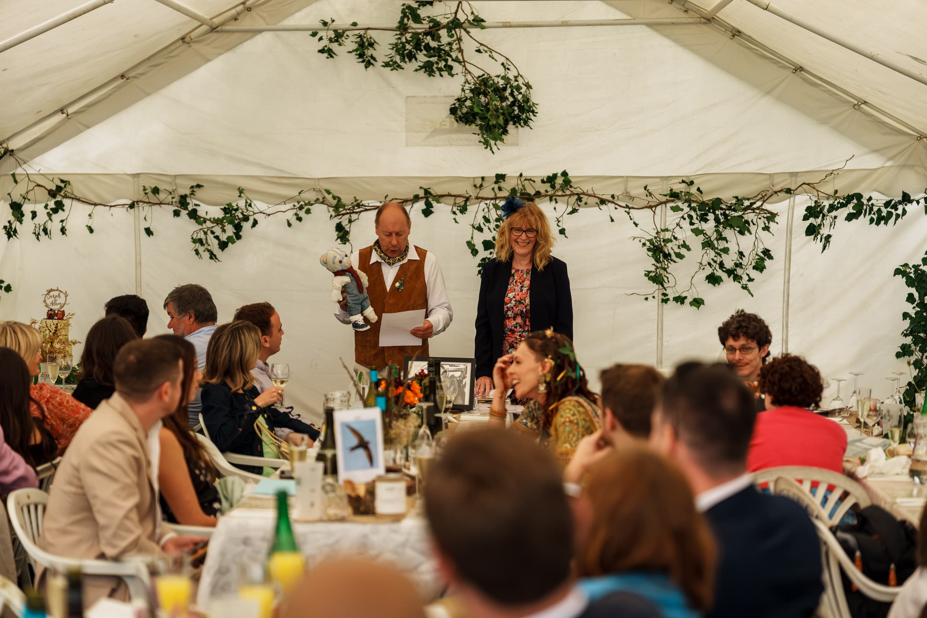 A speech unfolding inside the tent as dinner settles into a more attentive room.