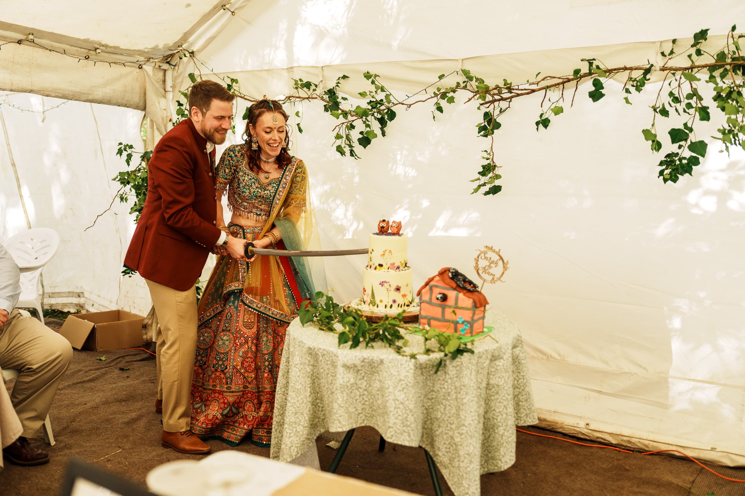 Adam and Sarah cutting the cake as dinner shifts from speeches into celebration again.