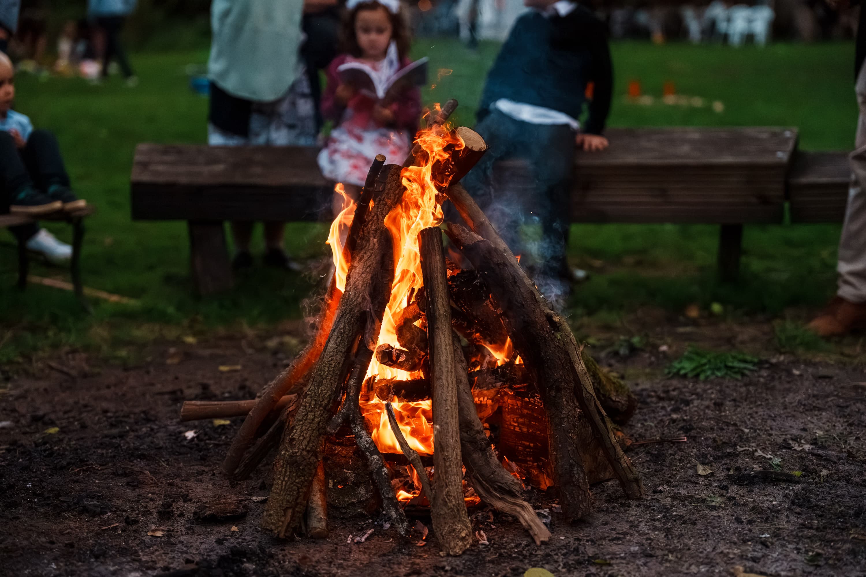 The bonfire marking the first real turn from dinner into night-time gathering.