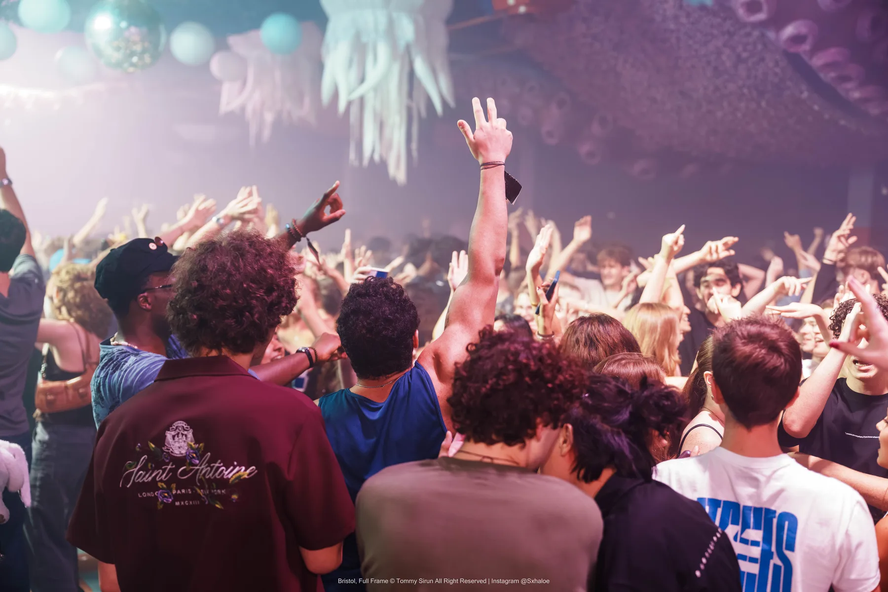 A crowd frame with energy and structure under difficult lighting.
