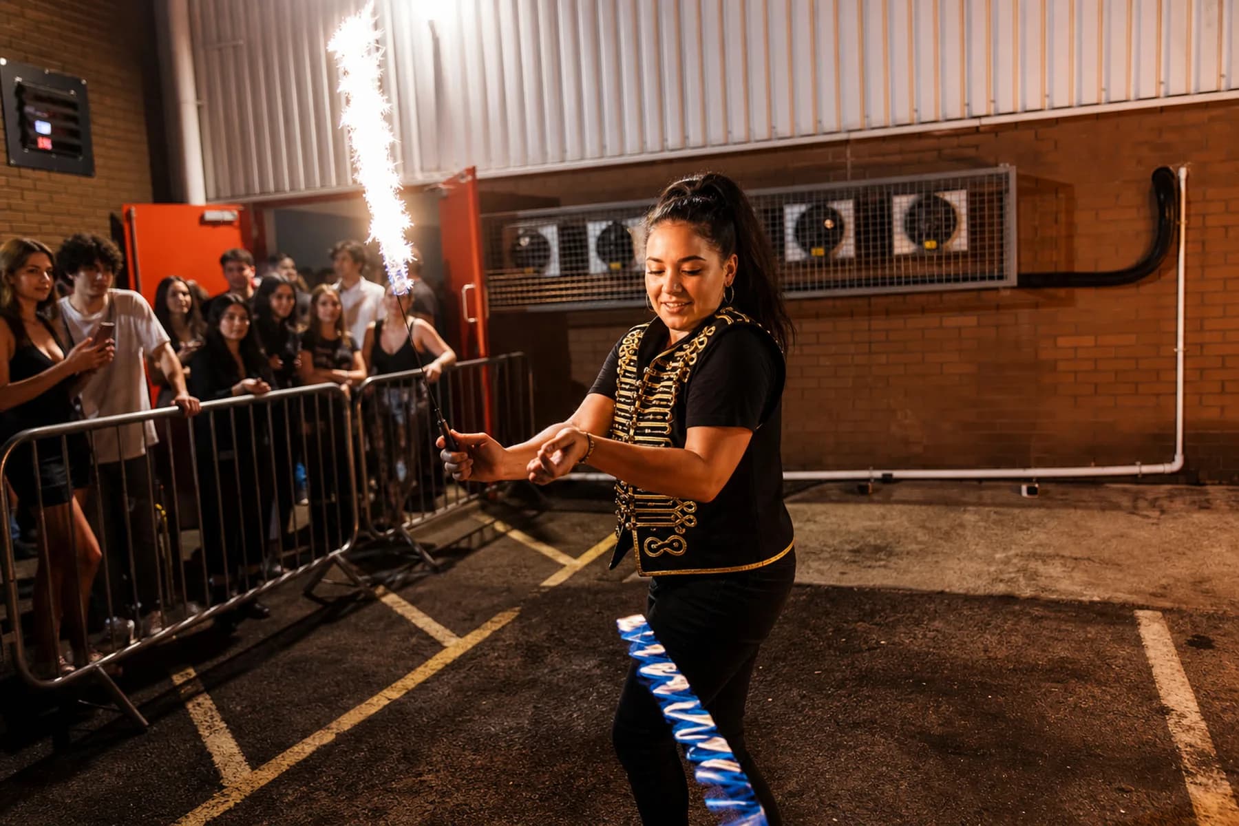 An event-team or performer-facing moment inside a late-night event environment.