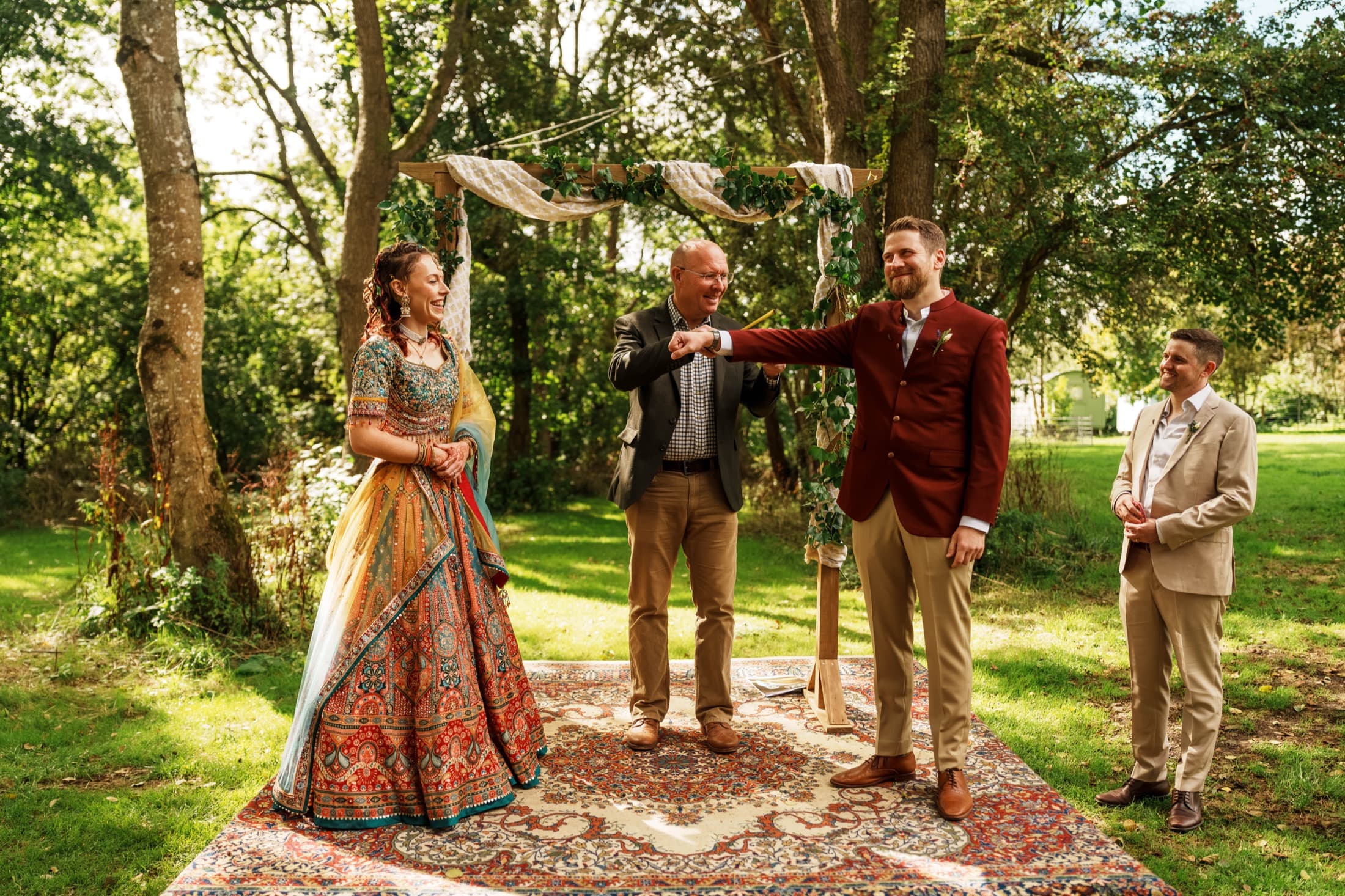 Outdoor wedding ceremony photographed by Vision Run with guests gathered around the couple.